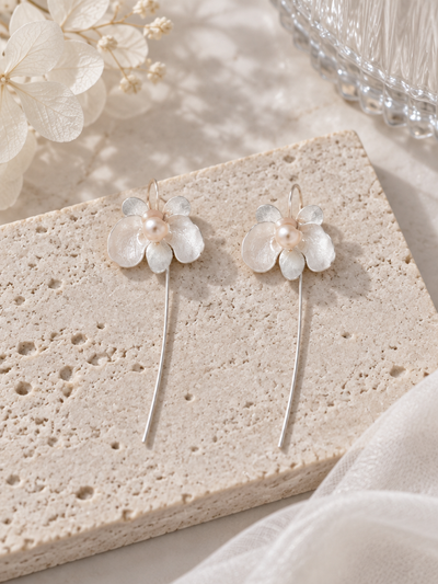 BOLODOO ivory floral long drop earring worn with hair swept back