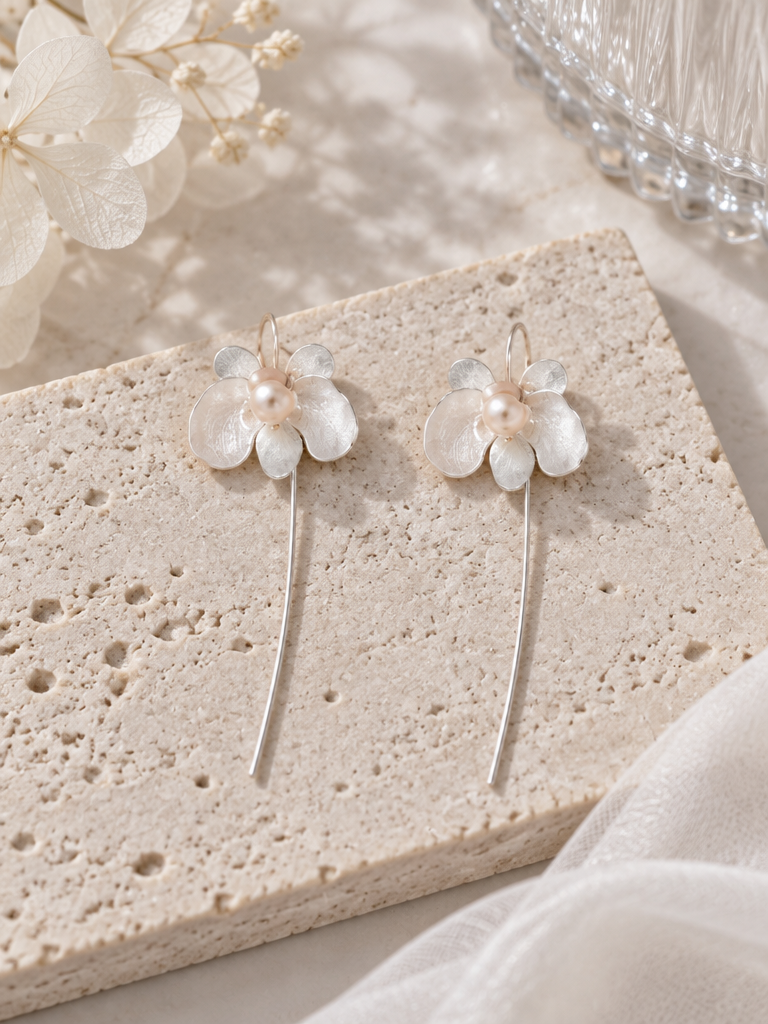 BOLODOO ivory floral long drop earring worn with hair swept back