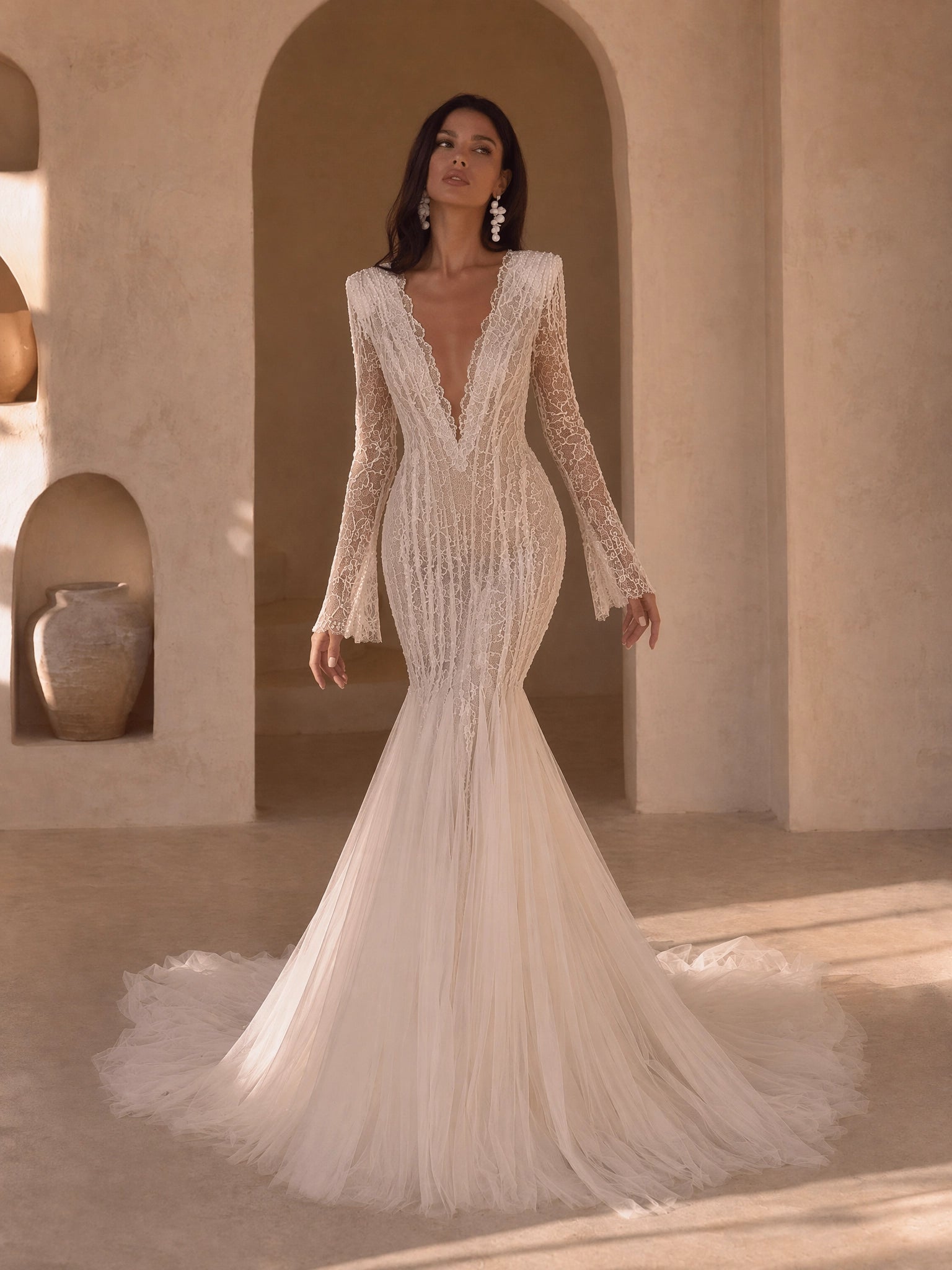 BOLODOO Ivory Deep V-Neck All-Over Mesh Lace Embroidered Long Bell Sleeve Mermaid Wedding Gown - front view 2 with bell cuff sleeves and sweeping train