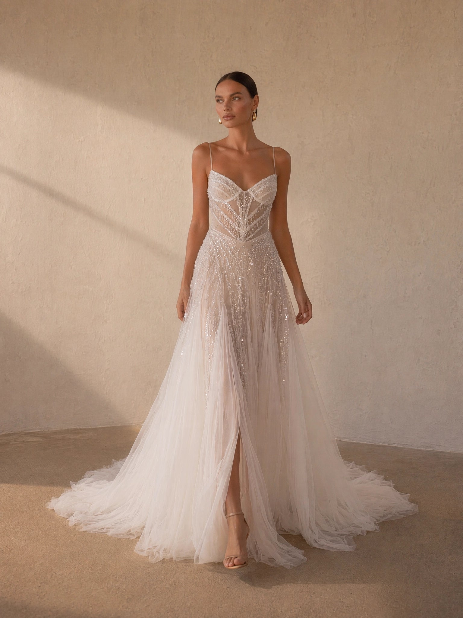 BOLODOO Ivory Spaghetti Strap Sweetheart All-Over Sequin Crystal Beaded Sheer Boned Corset A-Line Tulle Wedding Gown - front view 2 with slit and feather-edge train