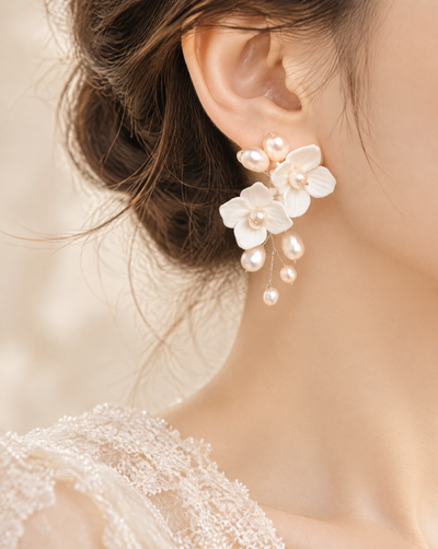 BOLODOO ivory flower and pearl-look bridal drop earring worn with a swept-back hairstyle