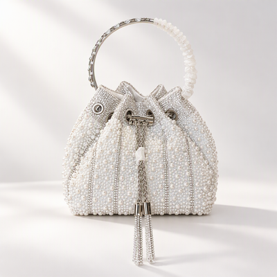 White pearl-effect beaded bridal bucket bag with a circular handle and sparkling tassels, front view