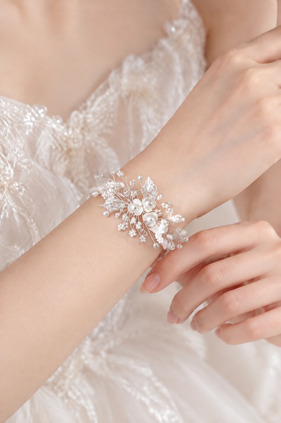 BOLODOO white floral pearl-look bridal bracelet worn on the wrist with a wedding dress