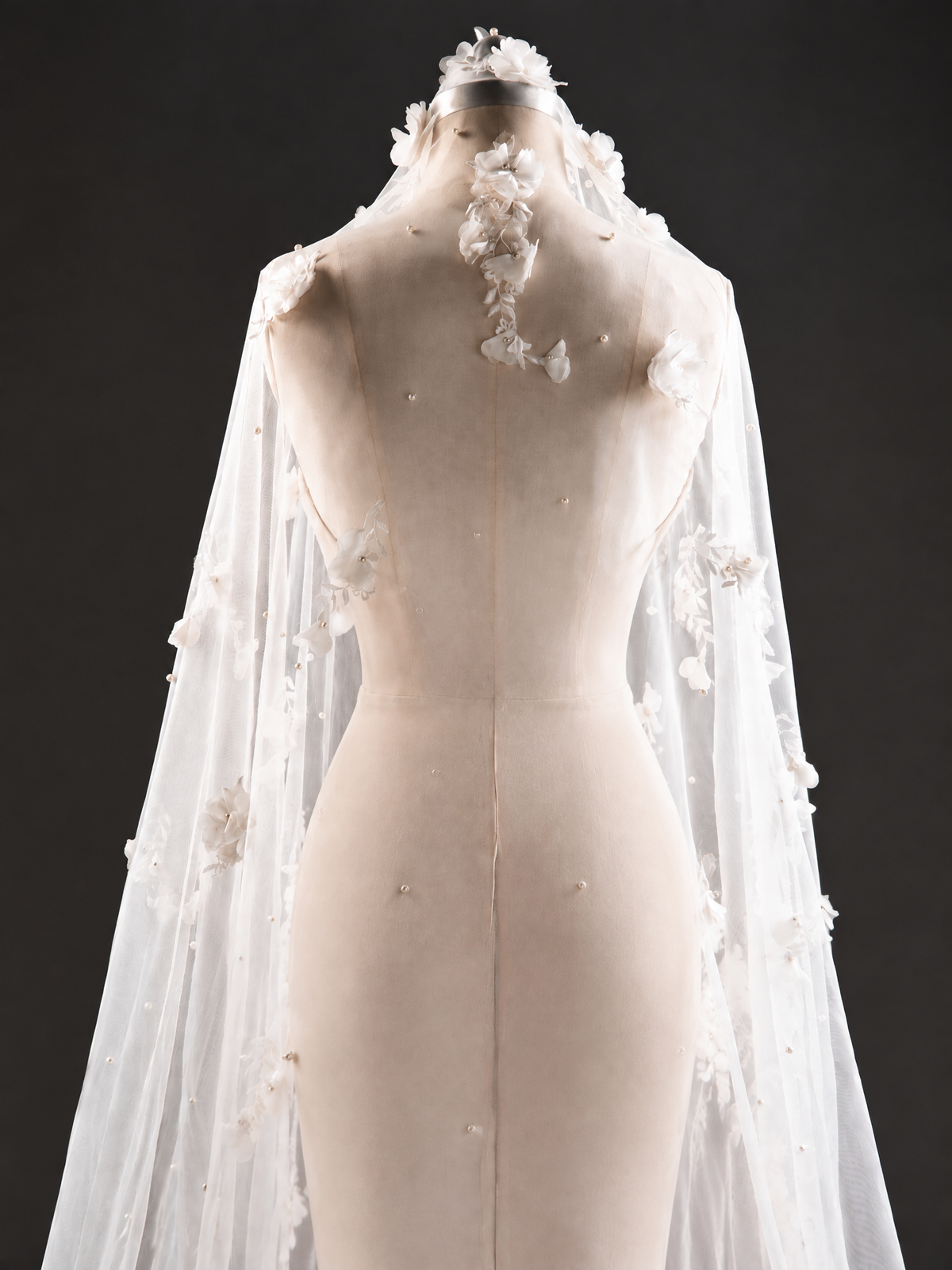 BOLODOO XCD022 white tulle bridal veil with dimensional floral appliques, flowing on a bride