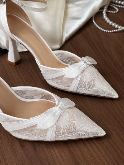 Close-up of BOLODOO XCD009 white bridal shoes showing floral lace, smooth trim and toe bows