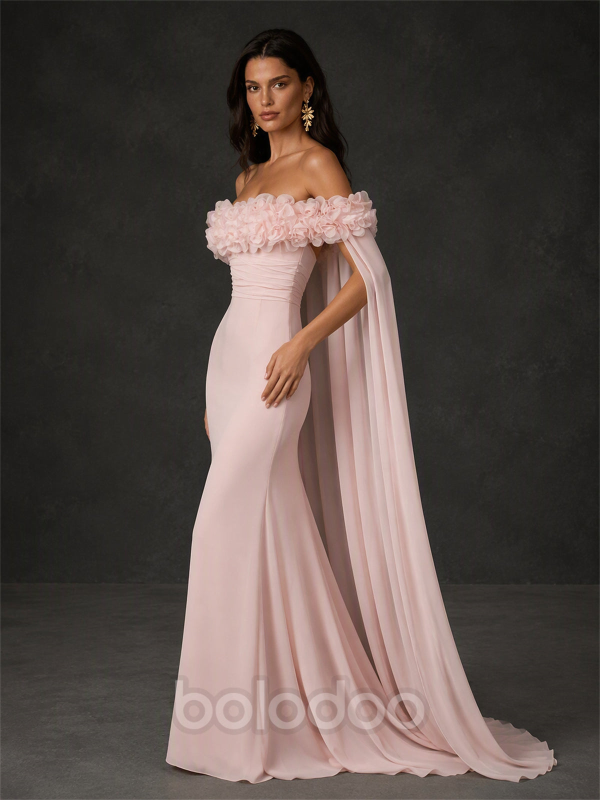 BOLODOO BX0013 blush pink 3D rose mermaid gown - three-quarter side view showing off-shoulder neckline, ruched crepe bodice and floor-length chiffon cape drape | BOLODOO watermark