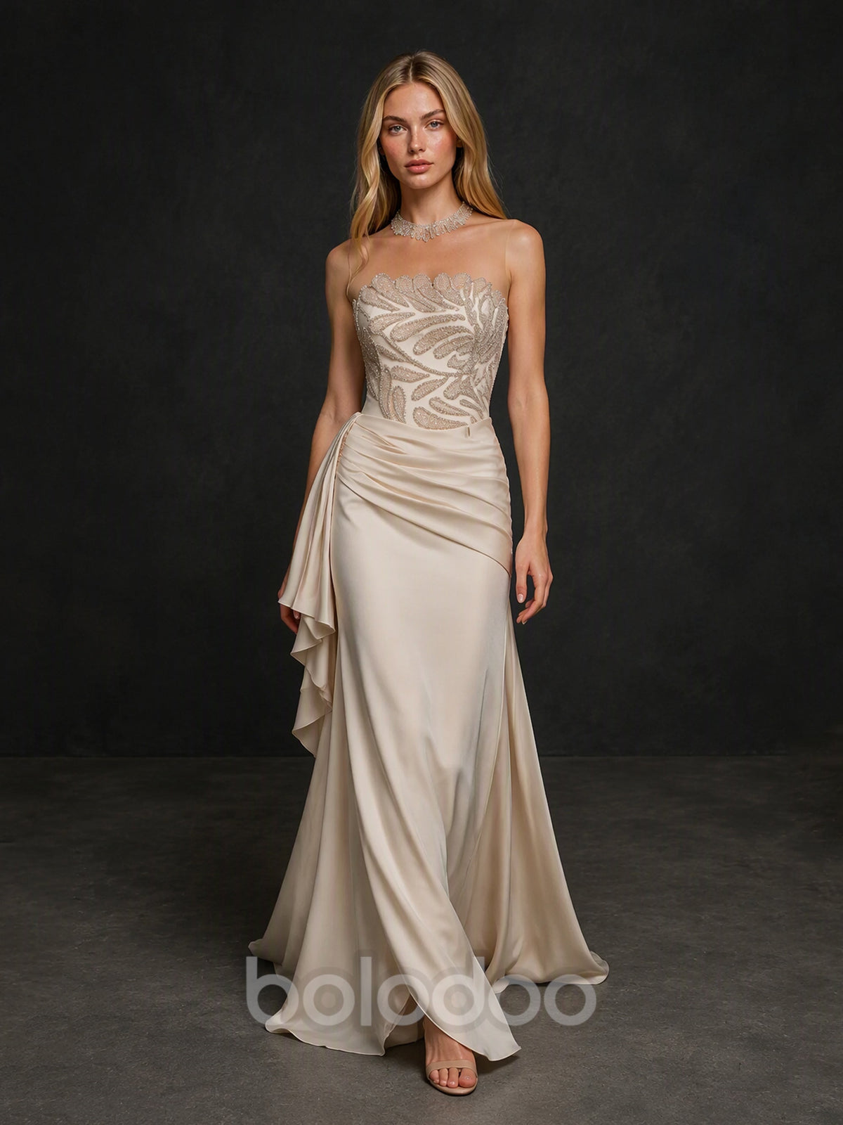 BOLODOO BX0017 champagne ivory illusion corset mermaid gown - front view showing crystal botanical leaf embroidery on sheer bodice and cascading satin ruffle drape panel | BOLODOO watermark