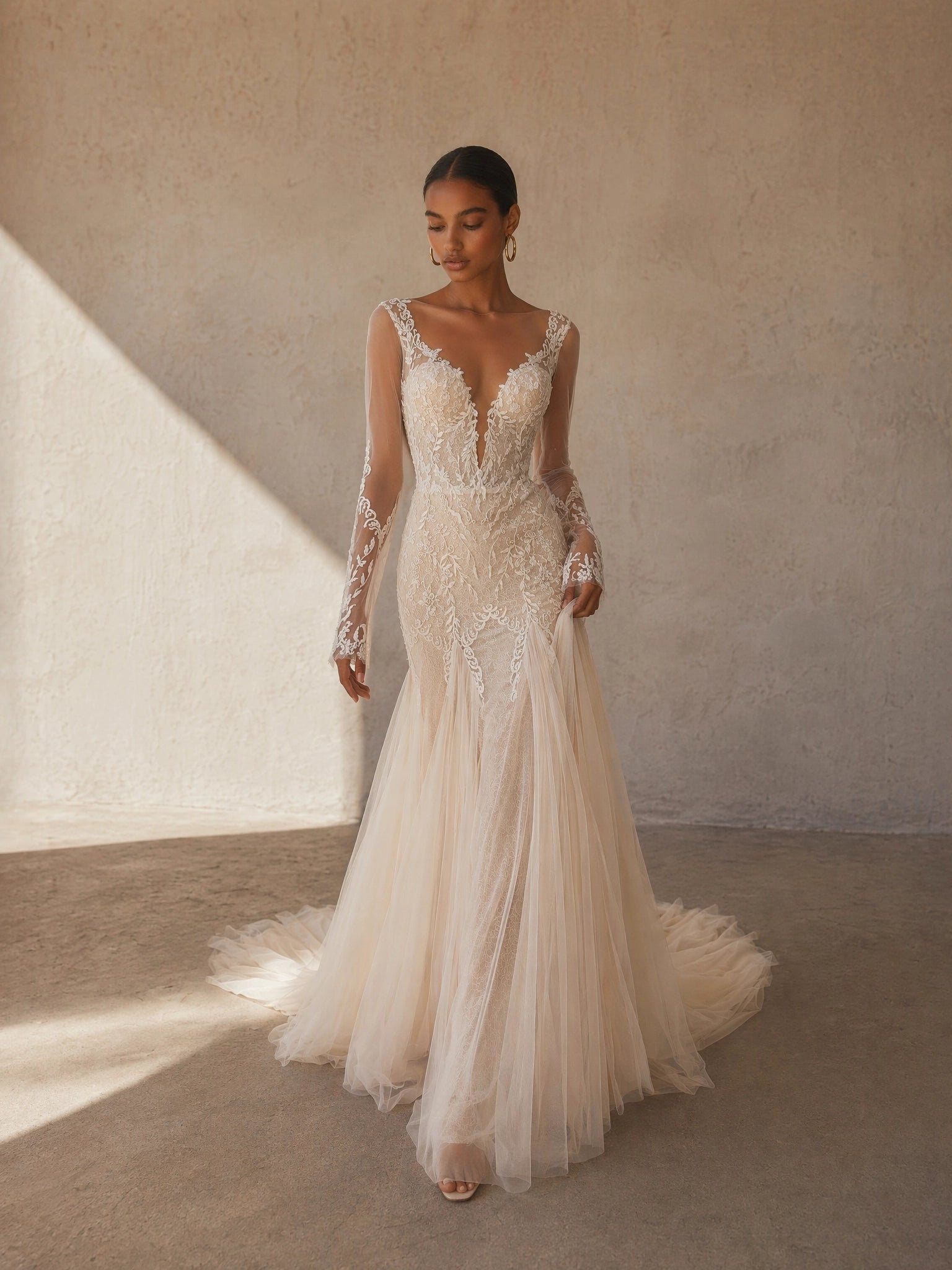 BOLODOO Champagne Deep V-Neck Sheer Long Sleeve Leaf Lace Embroidered Mermaid Wedding Gown - front view 2 with sweeping train