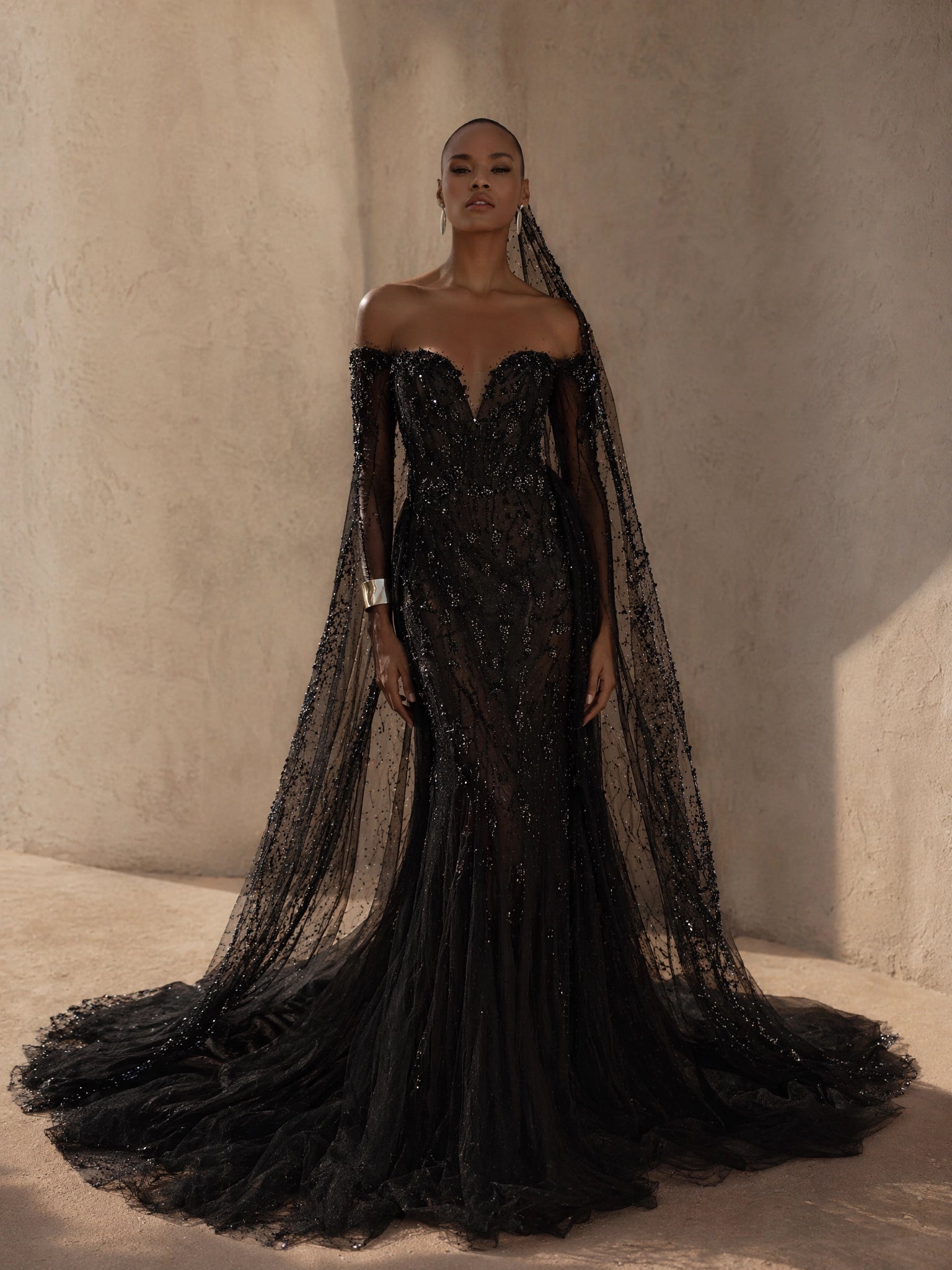 BOLODOO Black Off-Shoulder Sweetheart All-Over Sequin Crystal Beaded Mermaid Evening Gown - full front view with dramatic floor-length cape sleeves